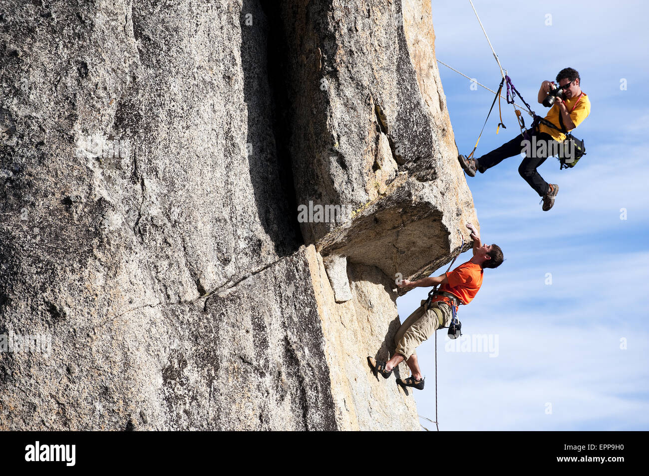 A photographer photographs a rock climber in Calif. Stock Photo