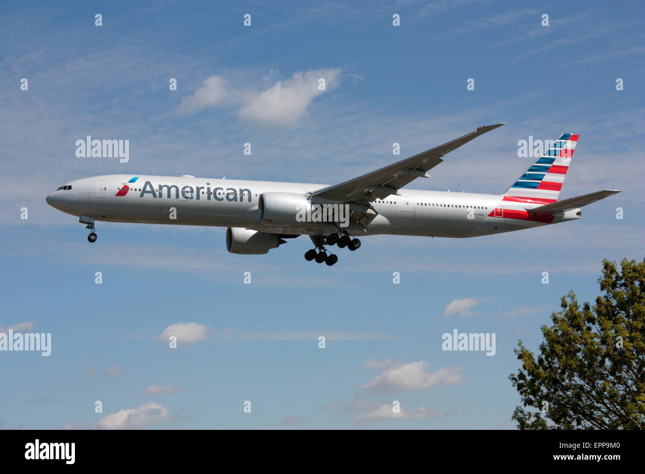 American Airlines Boeing 777-300ER long haul passenger jet approaching London Heathrow Airport after a transatlantic flight. Modern air travel. Stock Photo