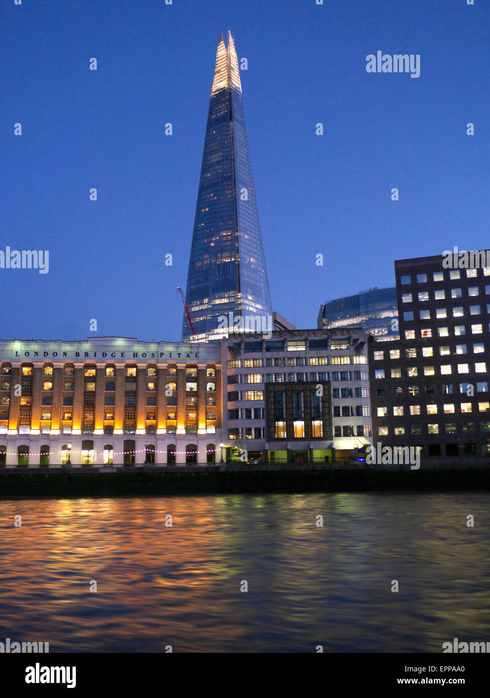View from Thames Clipper river boat navigating upstream of The Shard, London Bridge Hospital and City offices SE1 Stock Photo