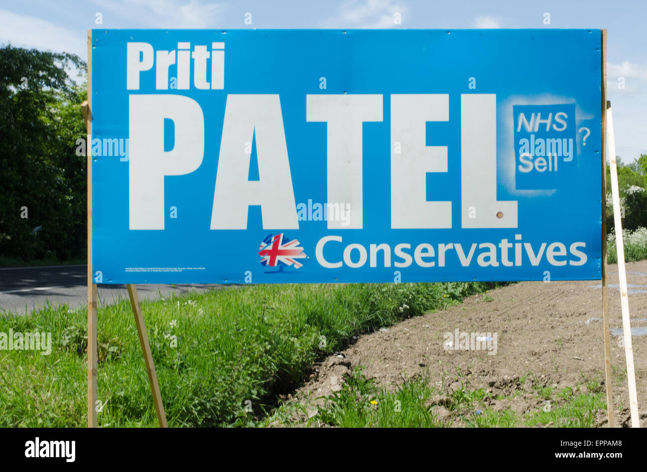 Road side poster for Priti Patel in the 2015 general election graffiti stating NHS sale ? Stock Photo