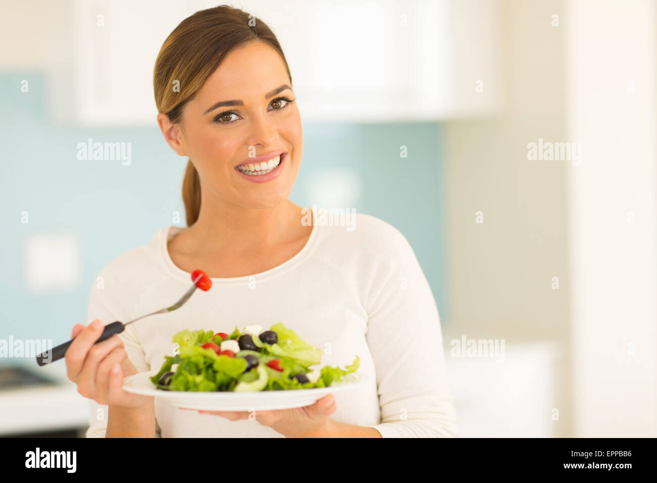 beautiful vegetarian eating salad at home Stock Photo