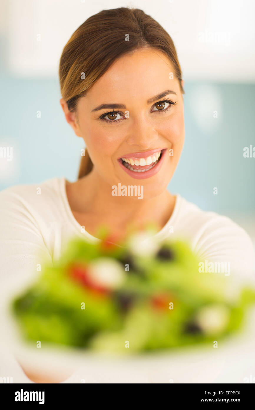 close up portrait of woman with plate of vegetable salad Stock Photo