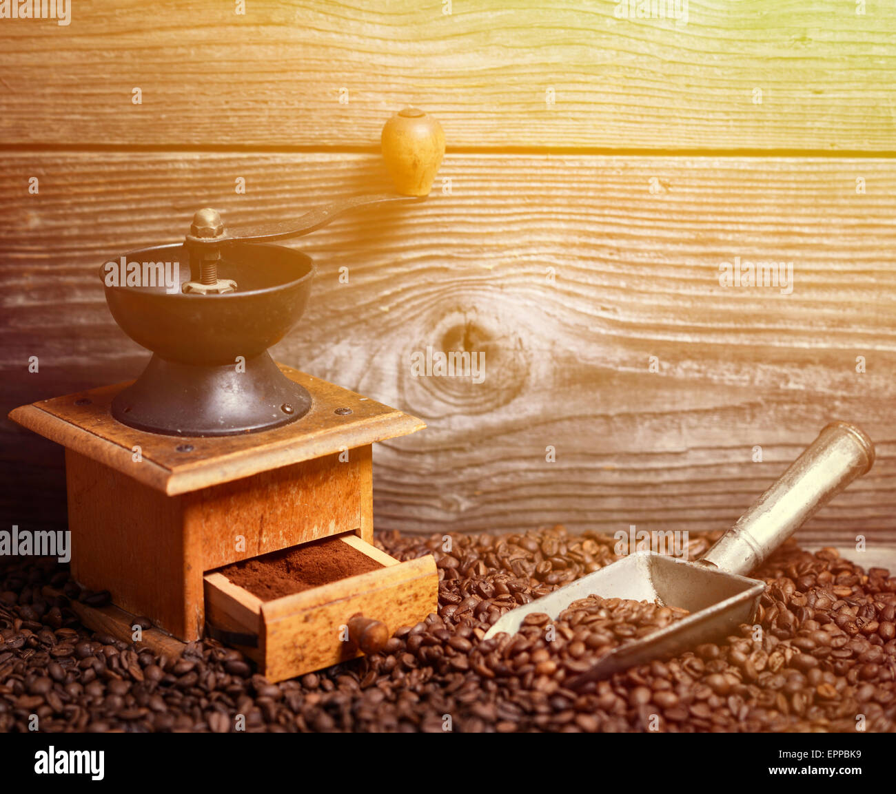 https://c8.alamy.com/comp/EPPBK9/manual-coffee-grinder-with-beans-and-vintage-scoop-on-wooden-background-EPPBK9.jpg