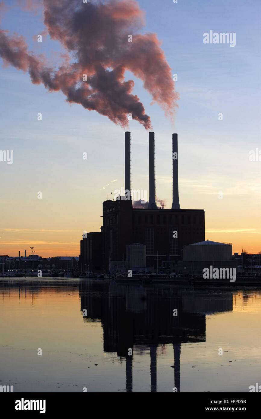 Power plant with smoke coming out of the chimneys in Denmark. Stock Photo