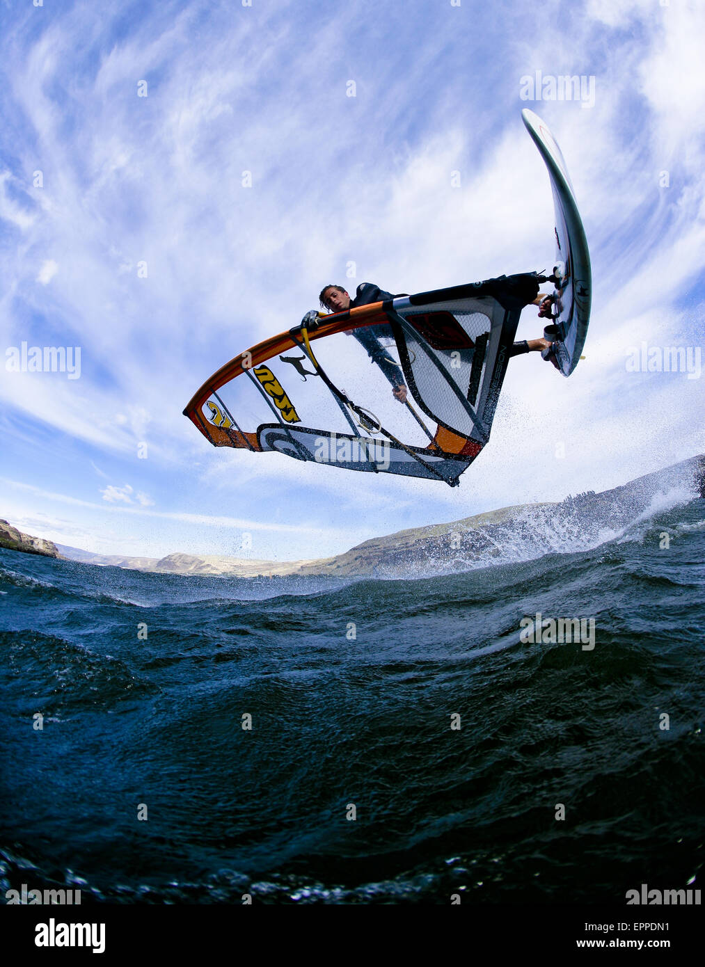 Windsurfer extends a shove it during a summer session at the Wall. Stock Photo