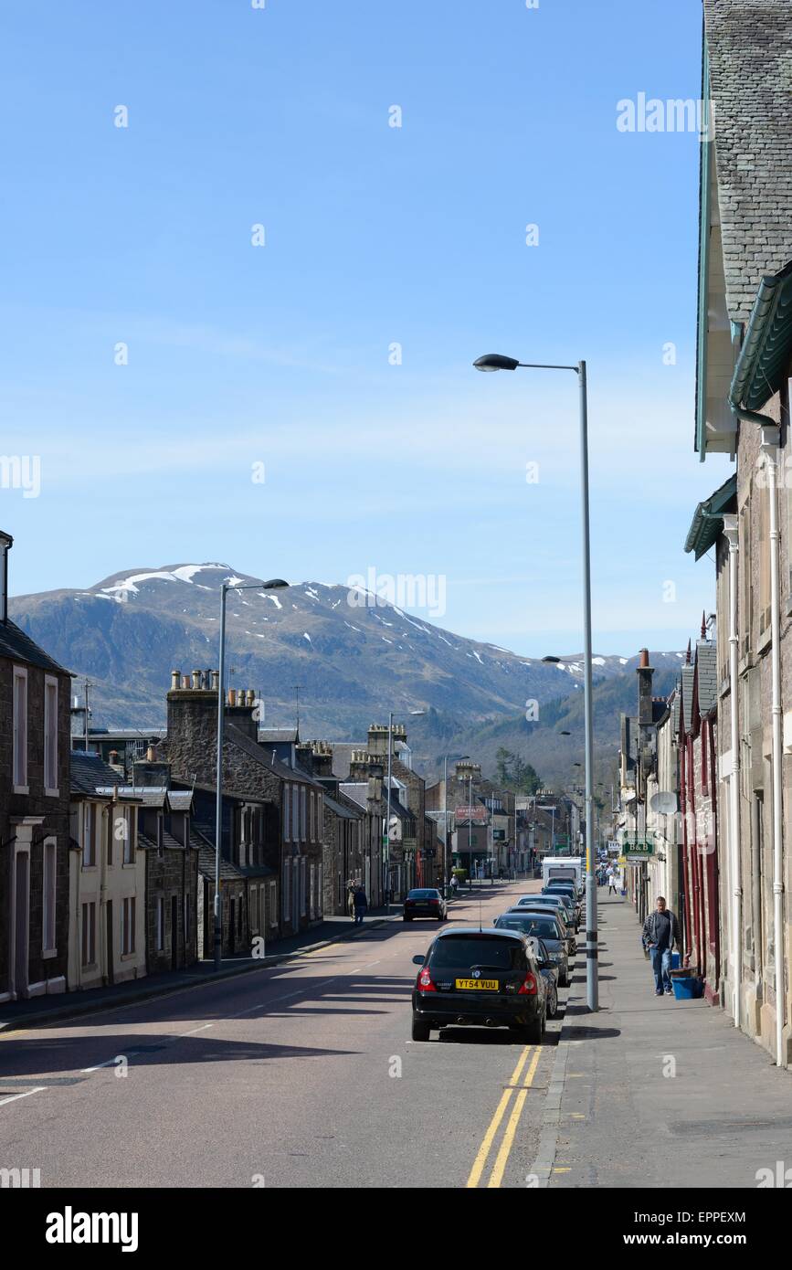 The main street running through Callander, Scotland towards Ben Ledi in the Trossachs. Stock Photo