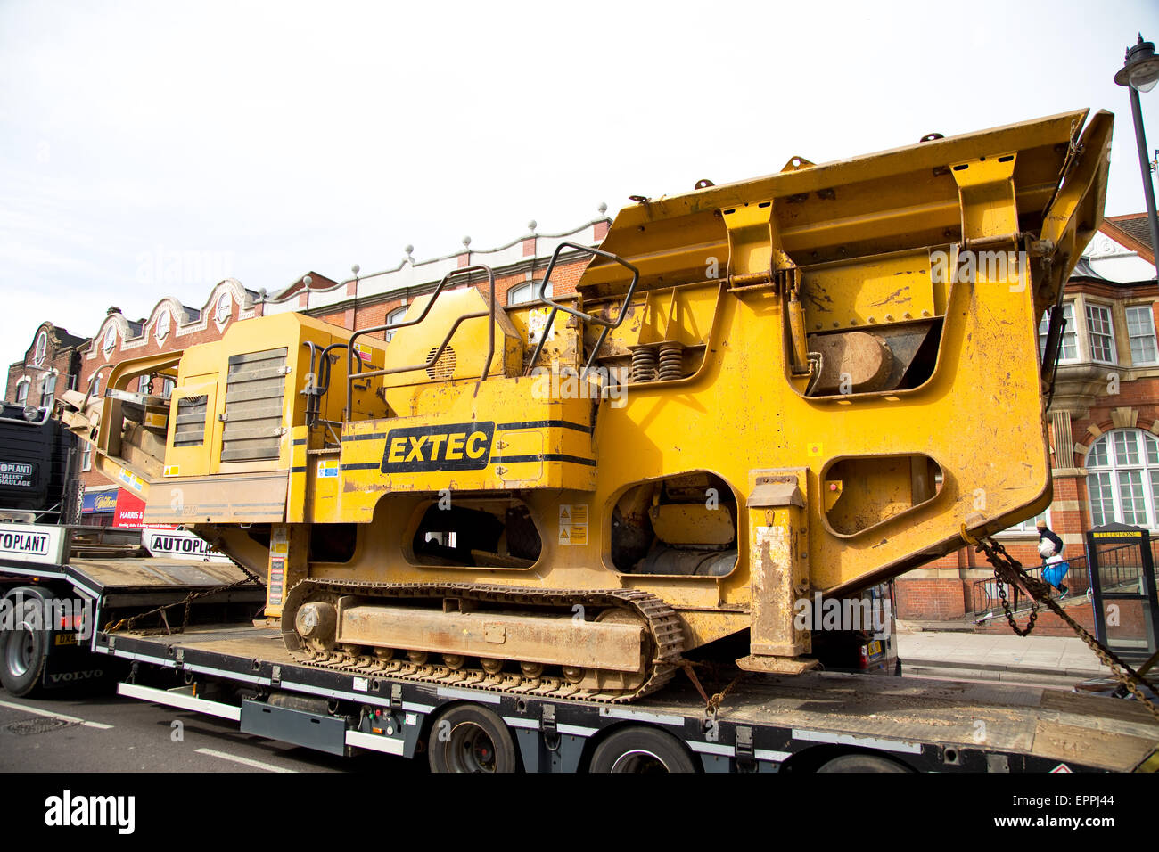LONDON - MARCH 30TH: A transporter  carries a rock crushing machine on March the 30th, 2015, in London, England, UK. Rock crushe Stock Photo