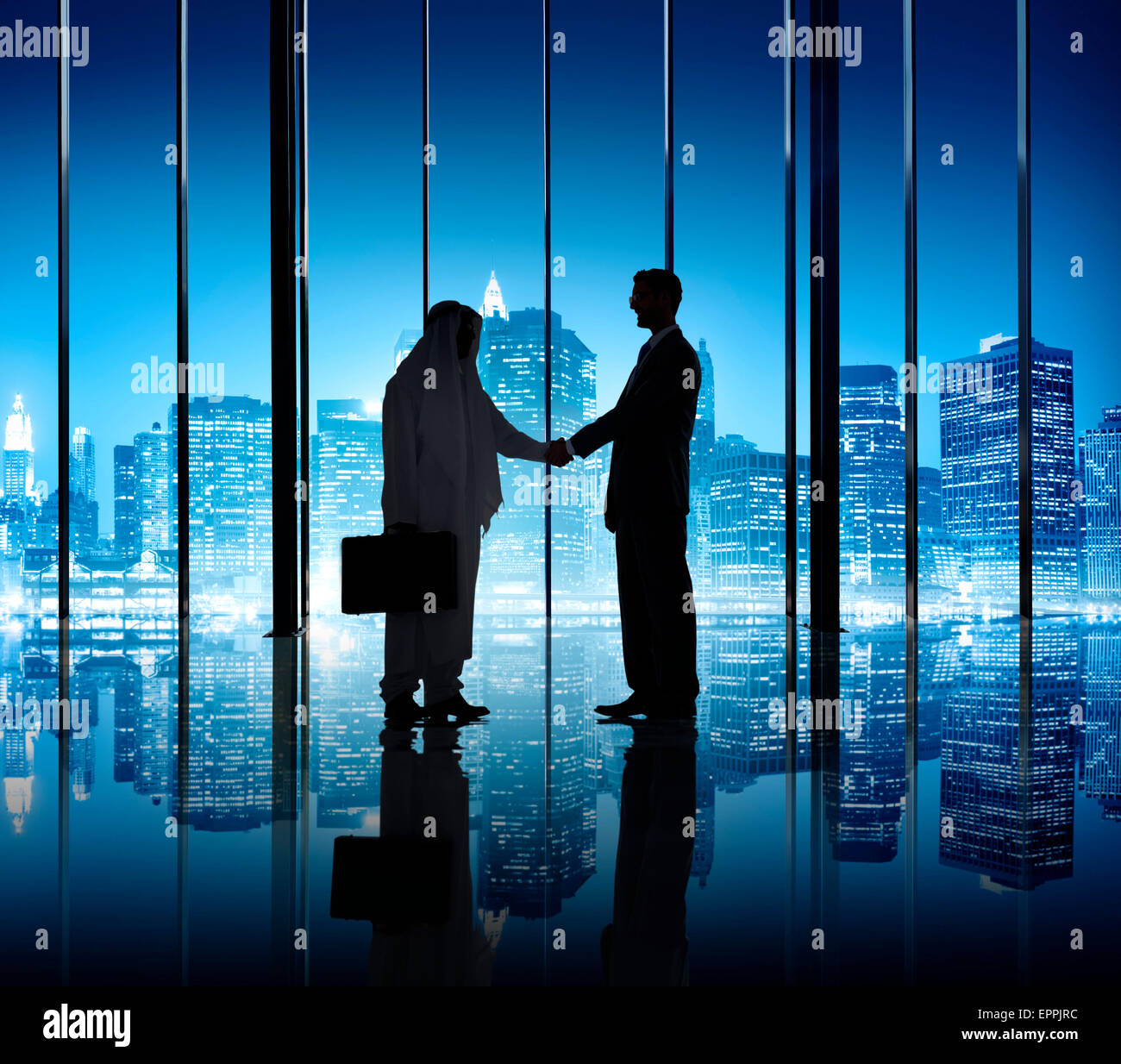 Two businessmen shaking hand in the office building Stock Photo - Alamy