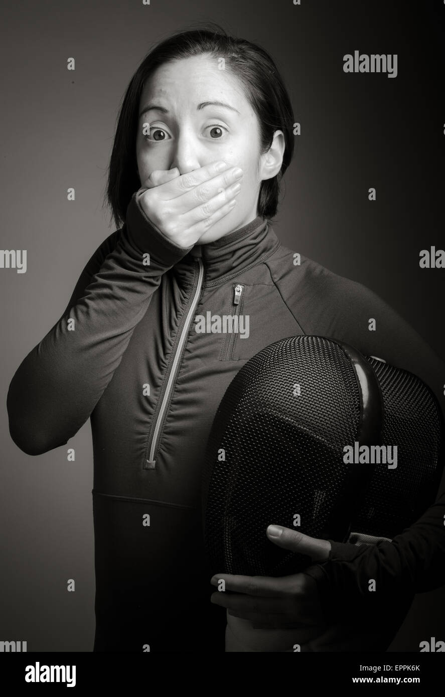 Female fencer hand over her mouth and shock Stock Photo