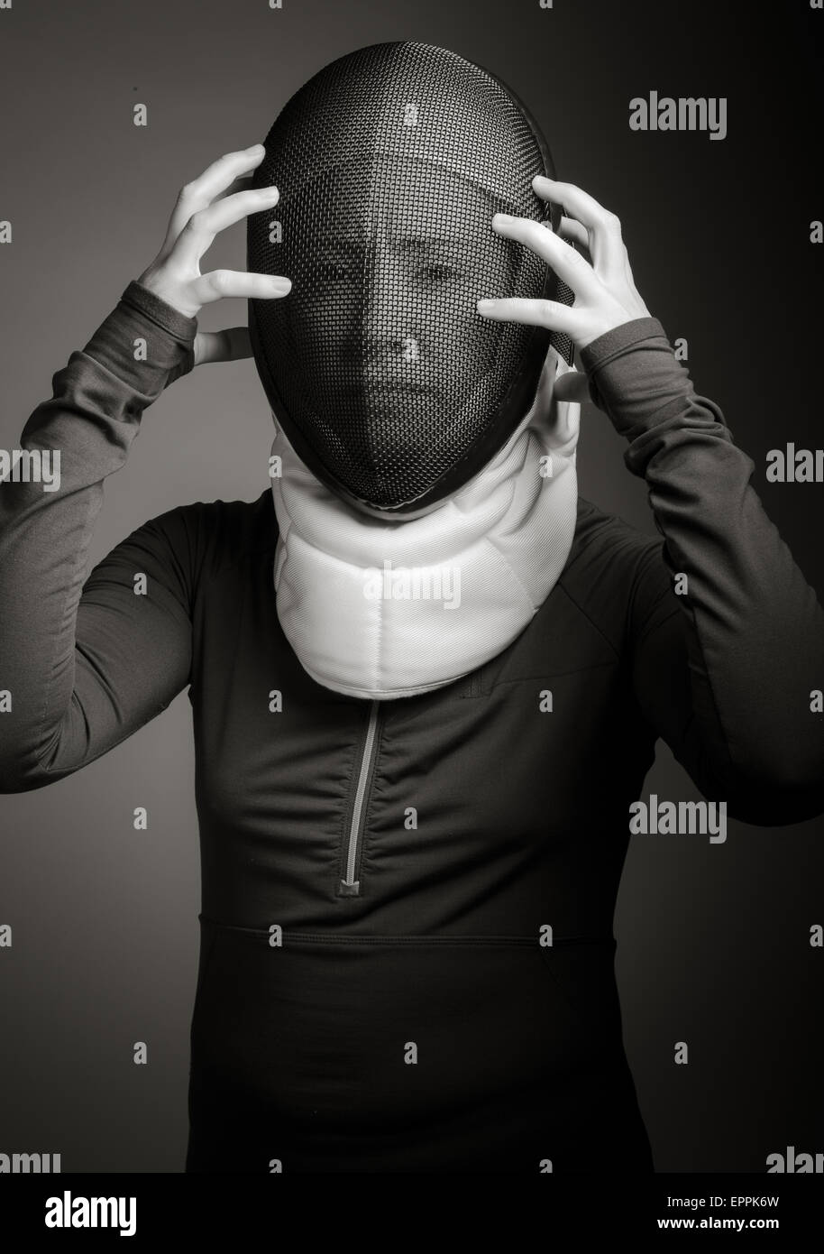 Female fencer in fencing mask looking frustrated Stock Photo