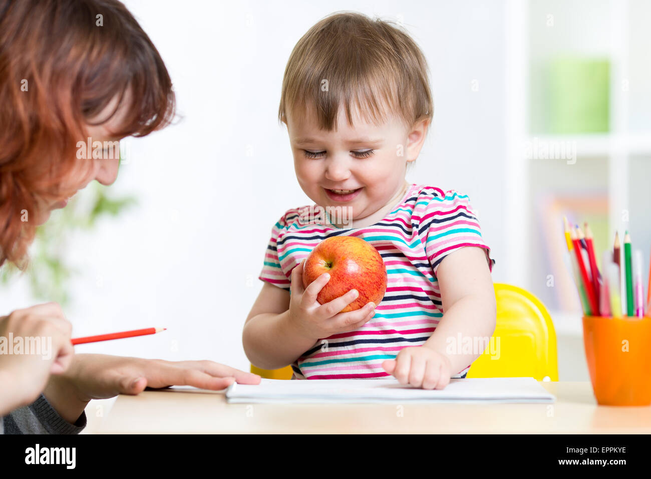 happy child girl and mother drawing with colorful pencils Stock Photo