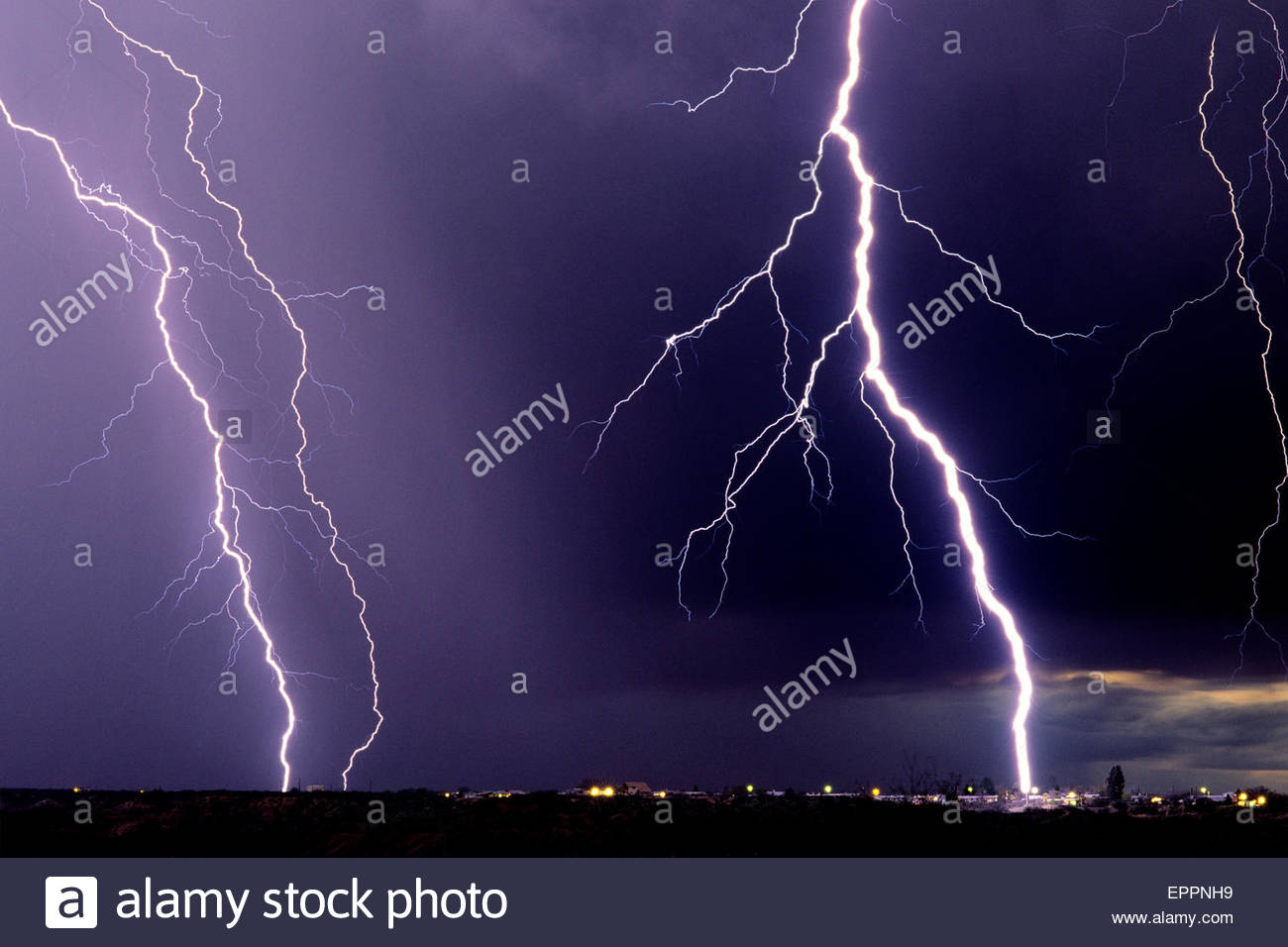 Huge Lightning Bolt hitting telephone pole in neighborhood, in an Stock
