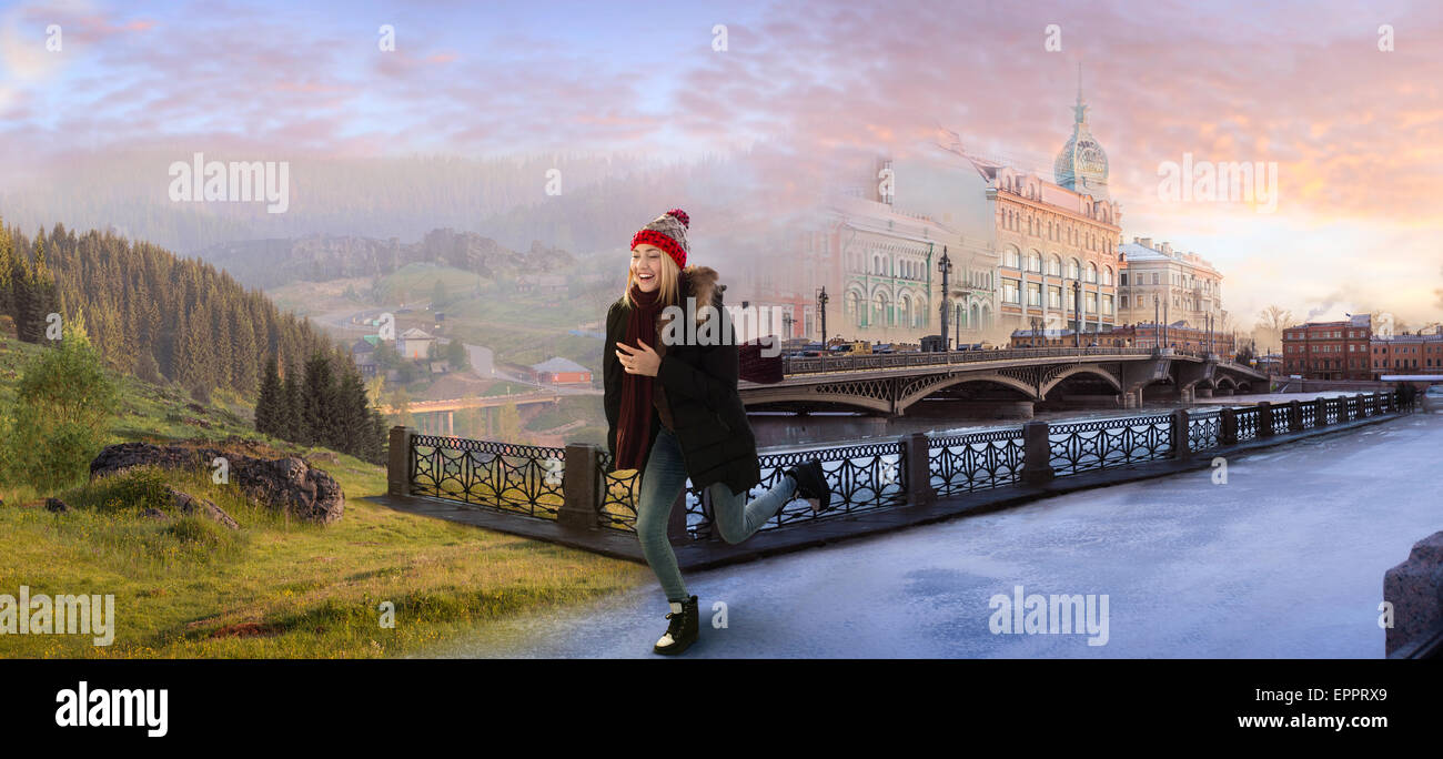 Young woman crossing the surreal imaginary border between winter city and summer countryside at the dawn. Escape from big city l Stock Photo