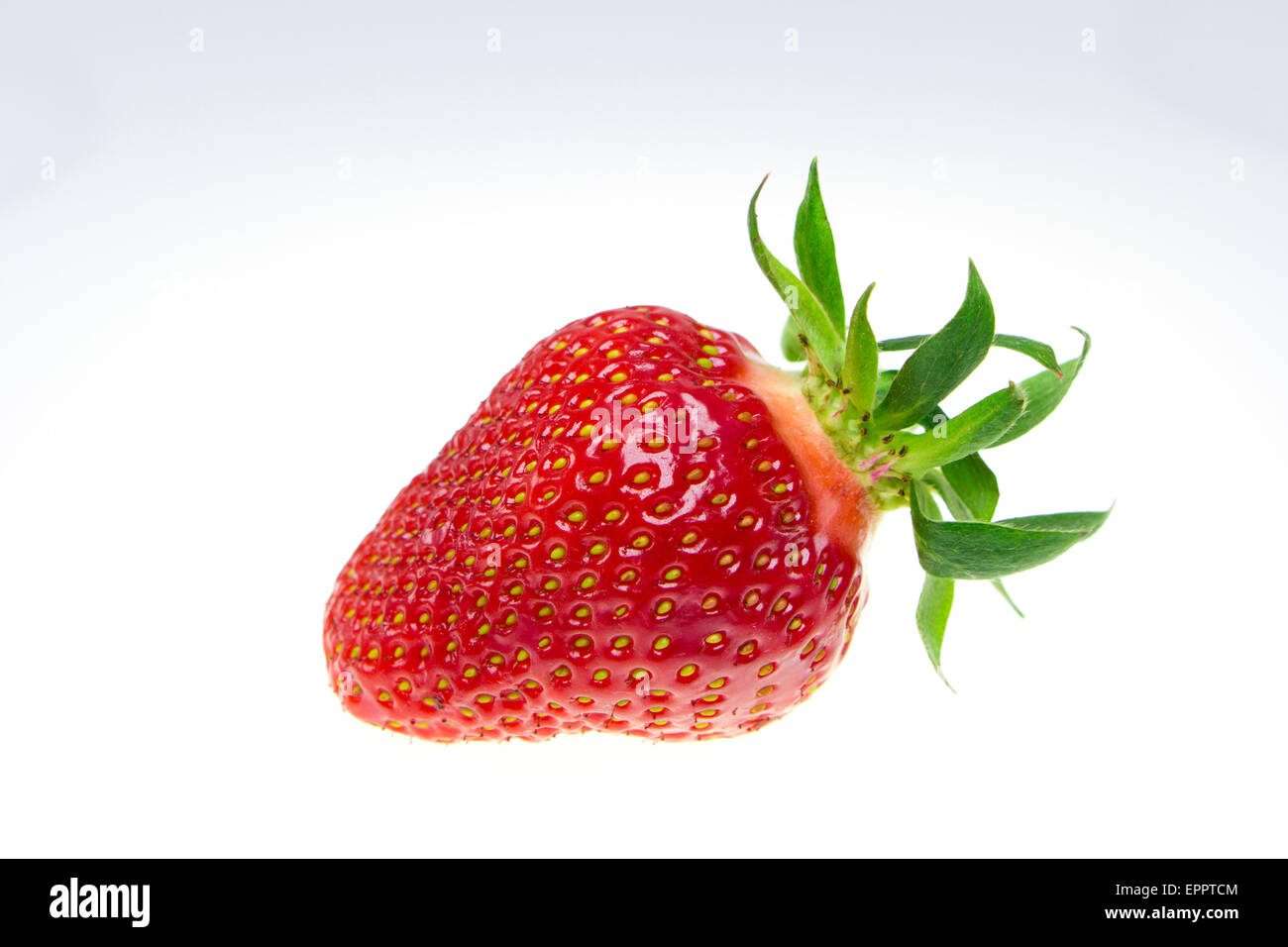 Single fresh strawberry placed on a white background Stock Photo - Alamy