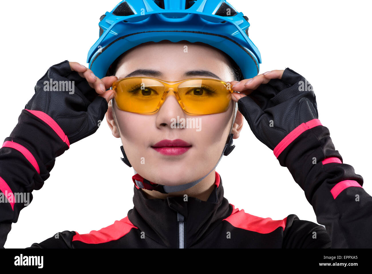 Young female cyclist adjusting sunglasses Stock Photo