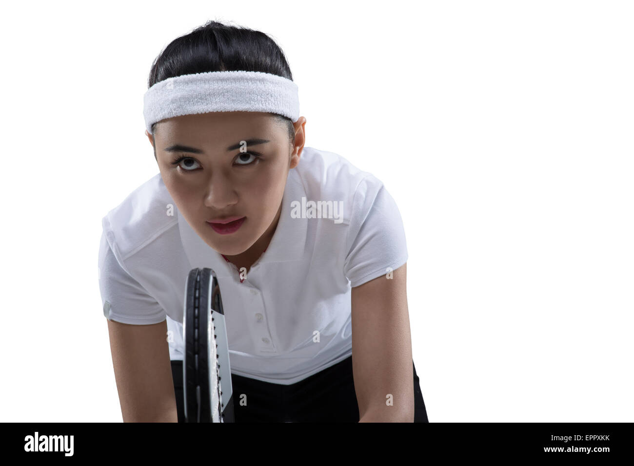 Young female tennis player poised in game Stock Photo