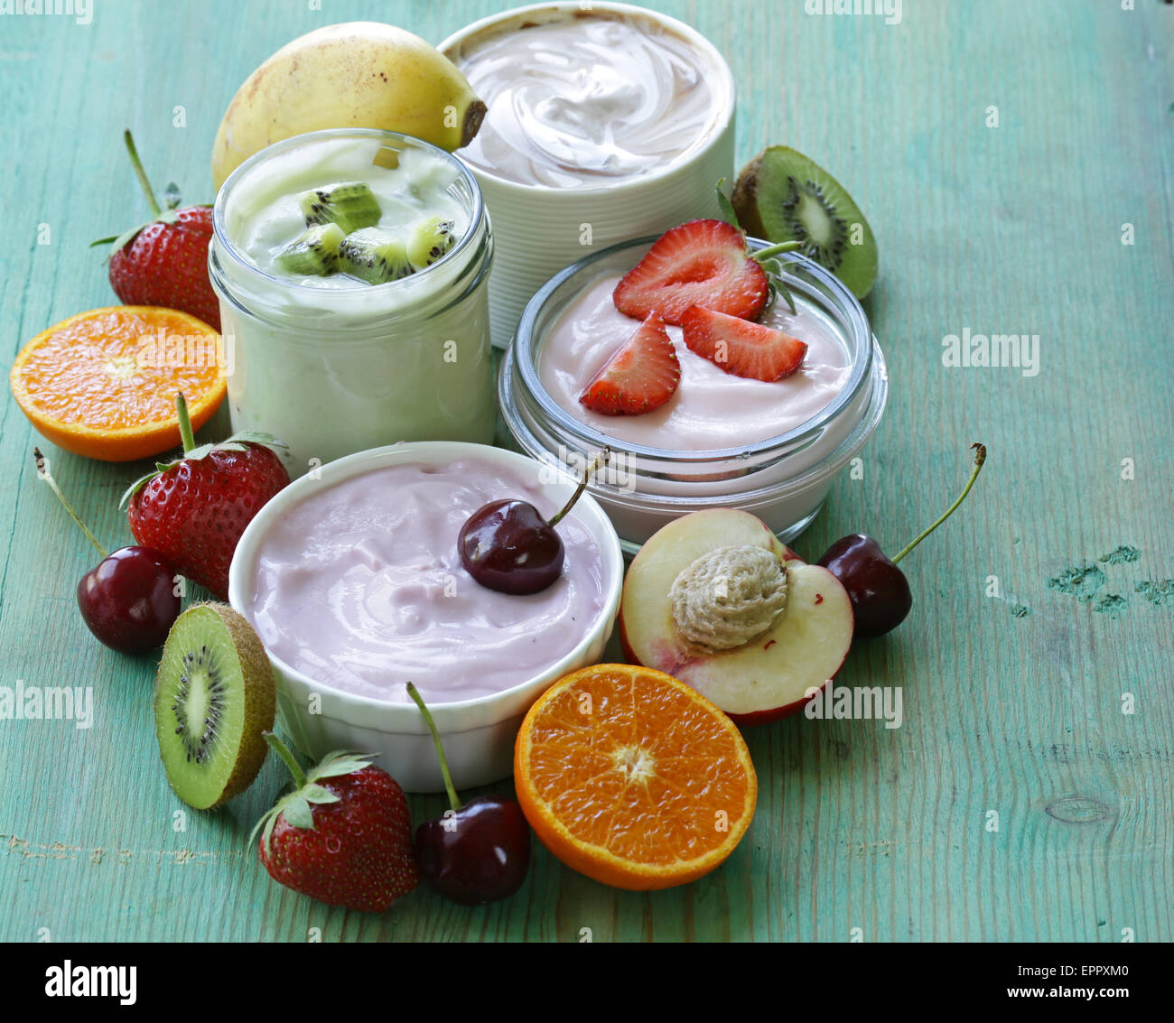 assortment of different yogurt for breakfast with berries and fruits