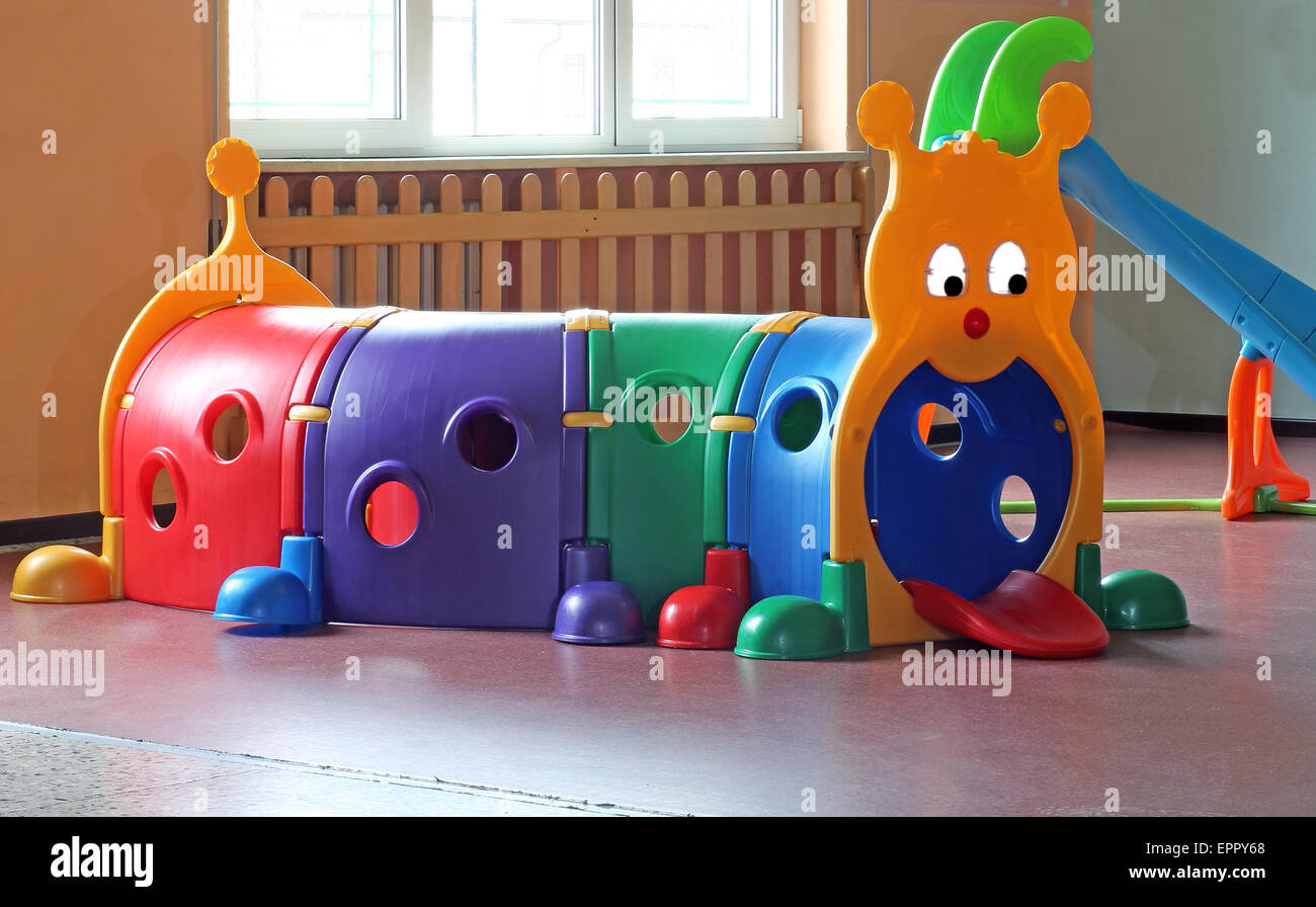 plastic tunnel for children's play in nursery room Stock Photo