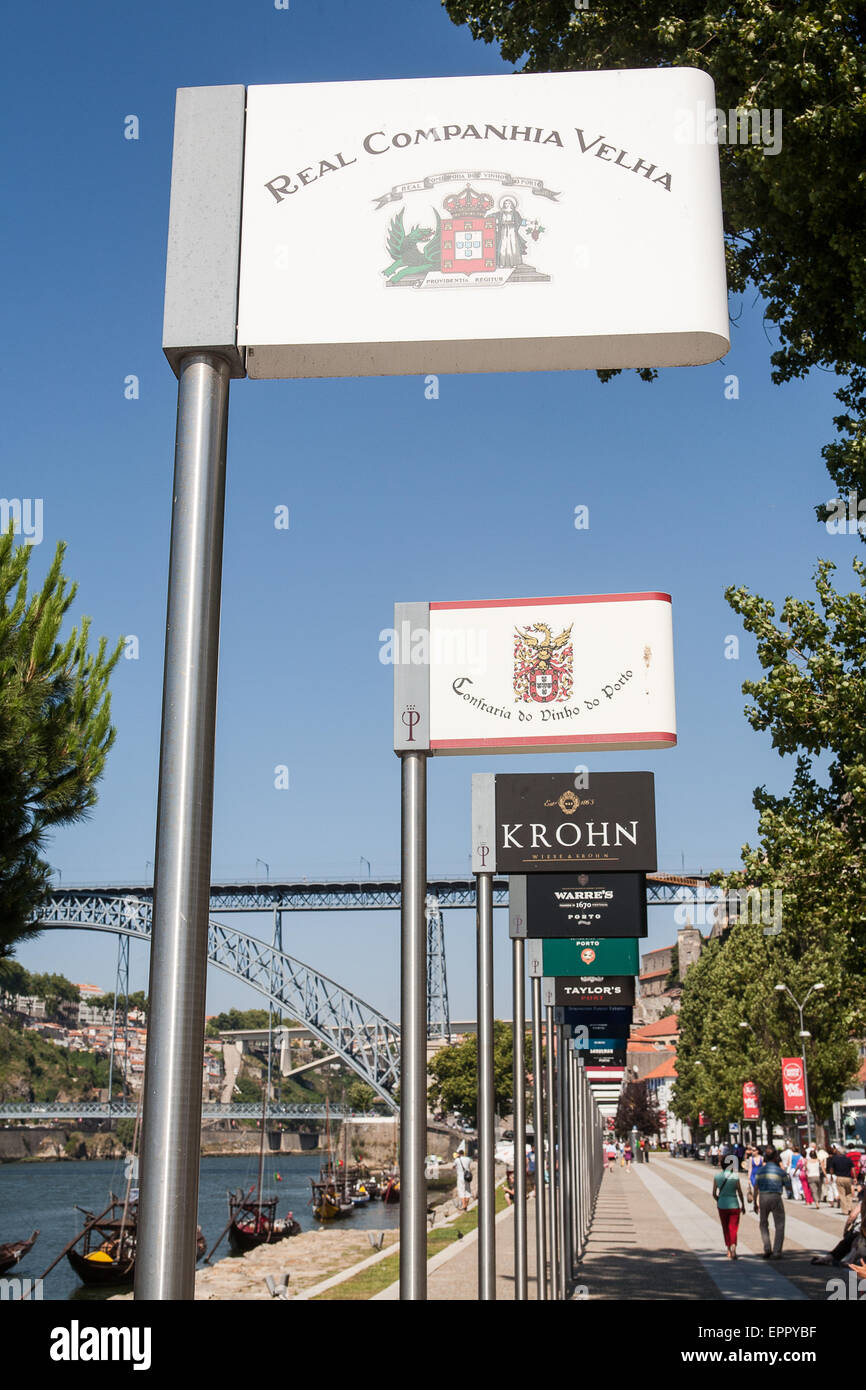 Signs for the Port wine companies that have wine cellars in Porto. The tour of the cellars ends with an opportunity to taste the famed drink. The Port wine cellars, also known as “lodges”(locally known as “caves”) where the world famous Port wine is stored and aged, are very popular tourist attractions. In Vila Nova de Gaia, region on the south bank of the Douro River. Porto, Portugal. Stock Photo