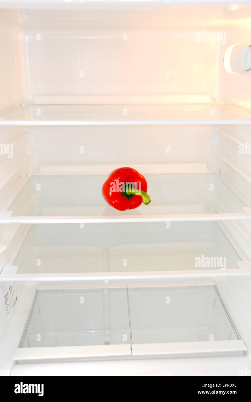 Single red pepper sitting alone in an empty fridge Bell pepper, also