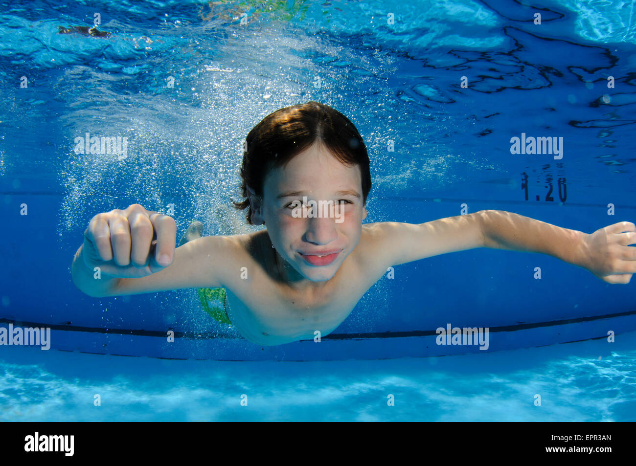 Young boy holds her breath while swimming underwater Stock Photo
