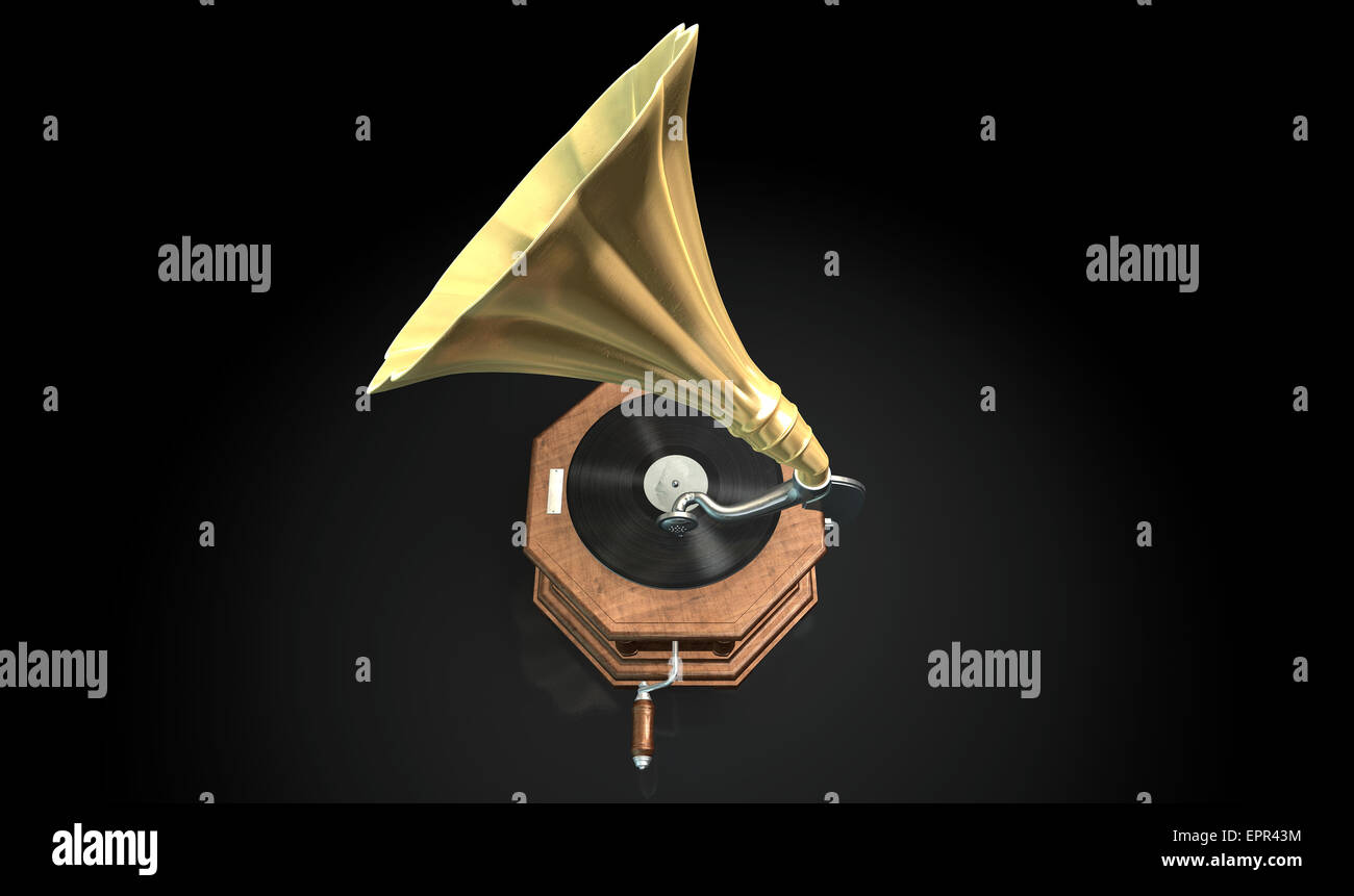 An old brass and wood gramophone with a vinyl record on it on an isolated dark background Stock Photo