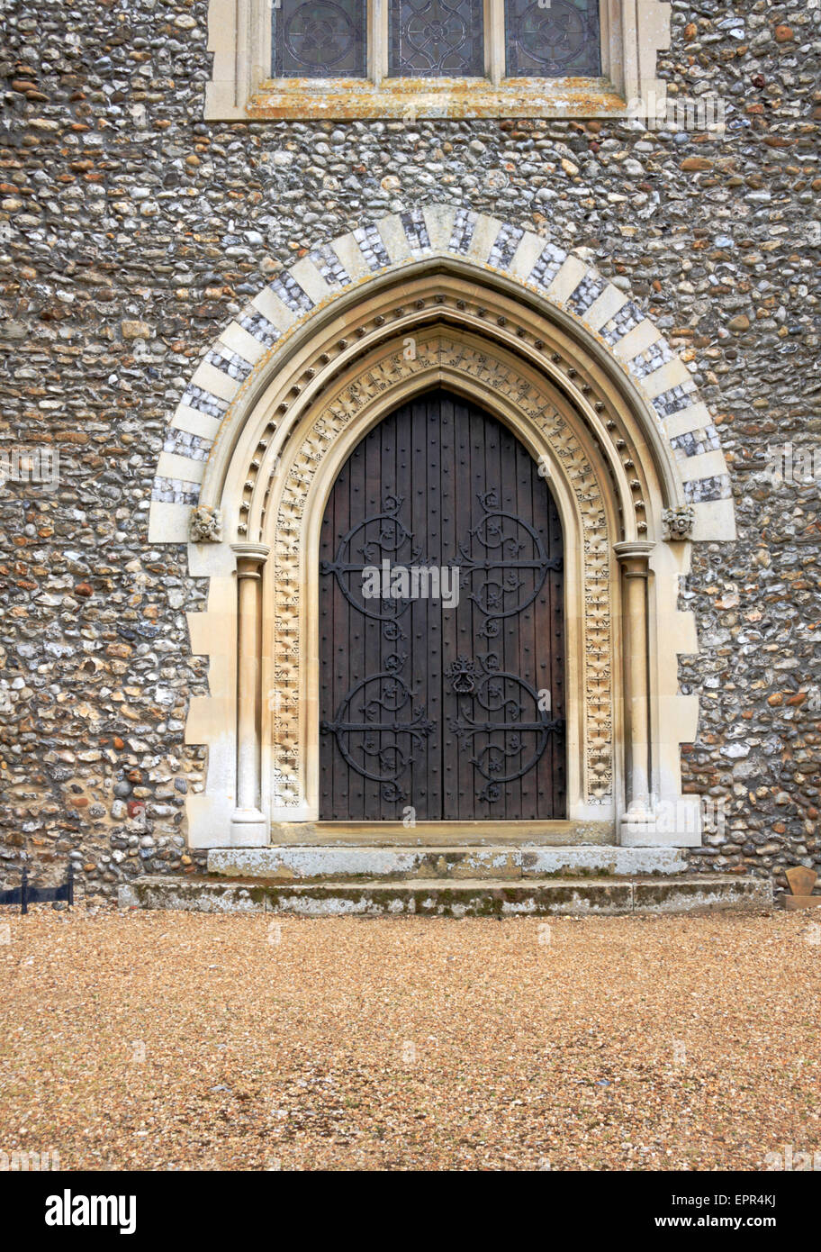 The west door addition to the tower of the parish church of St Withburga at Holkham, Norfolk, England, United Kingdom. Stock Photo