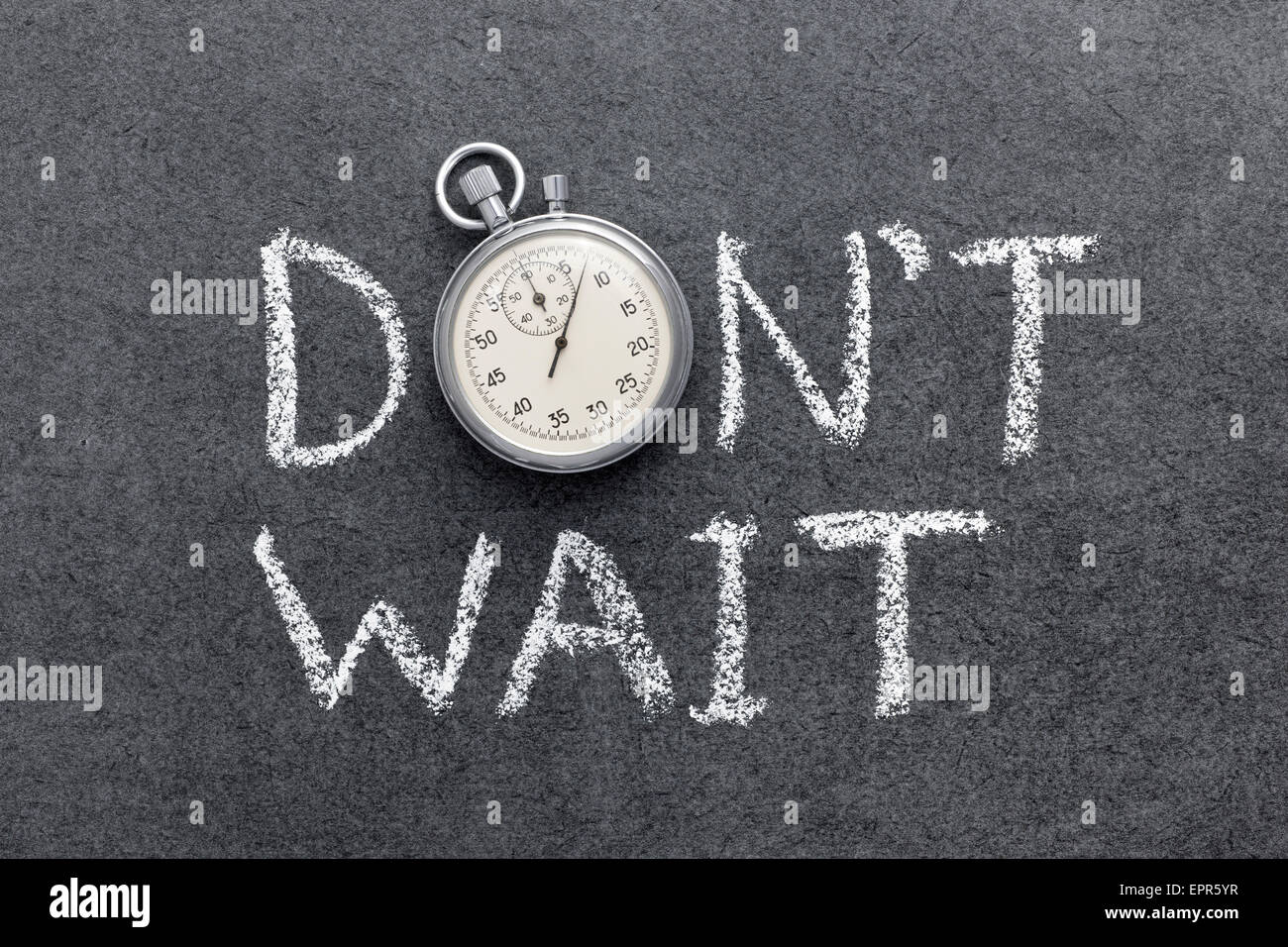 don’t wait phrase handwritten on chalkboard with vintage precise stopwatch used instead of O Stock Photo