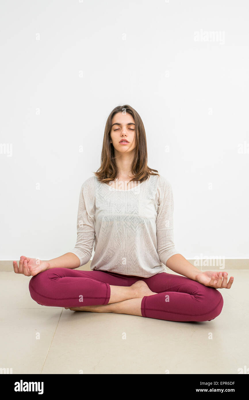 Young woman meditating indoors Model release available Stock Photo