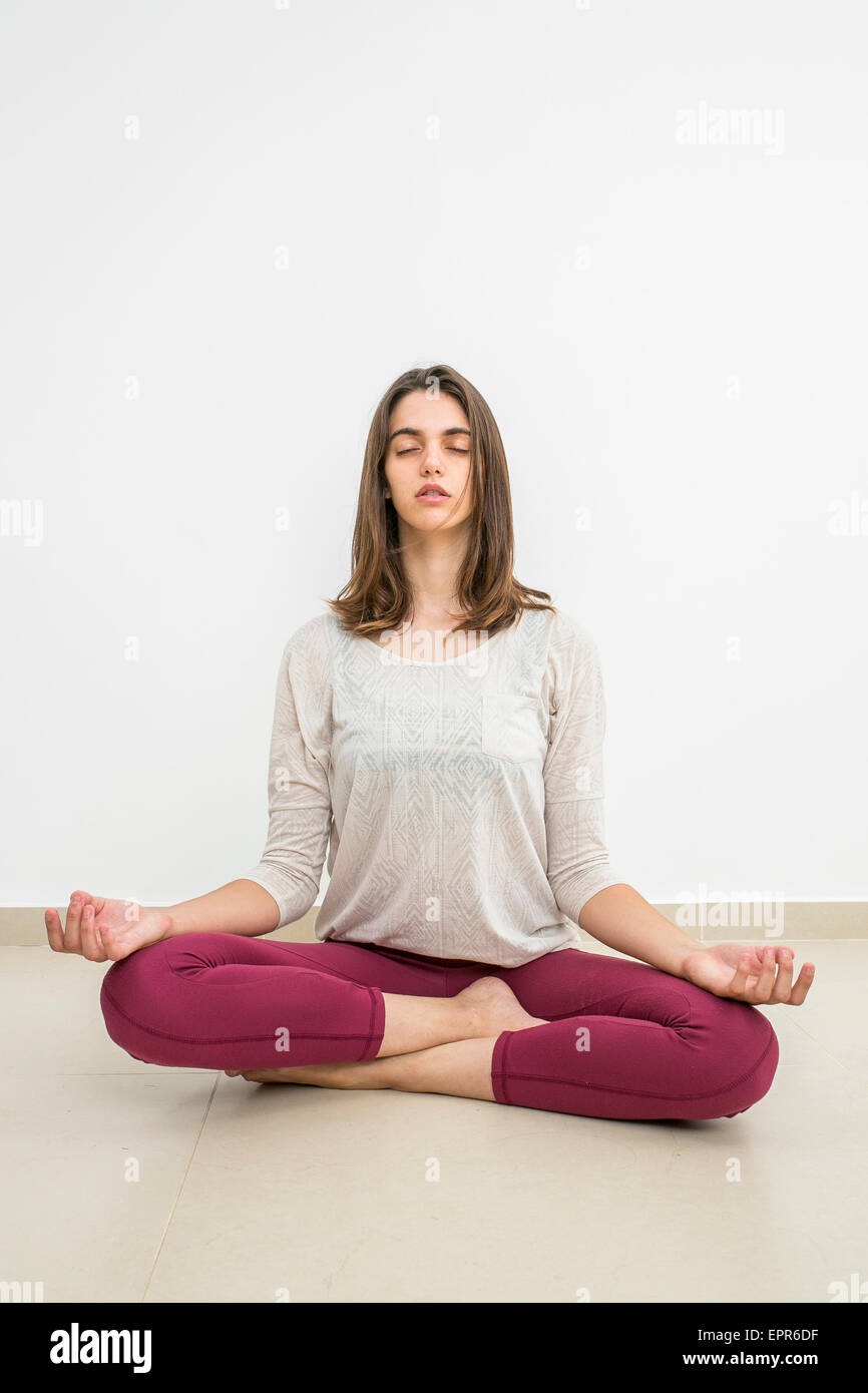 Young woman meditating indoors Model release available Stock Photo - Alamy