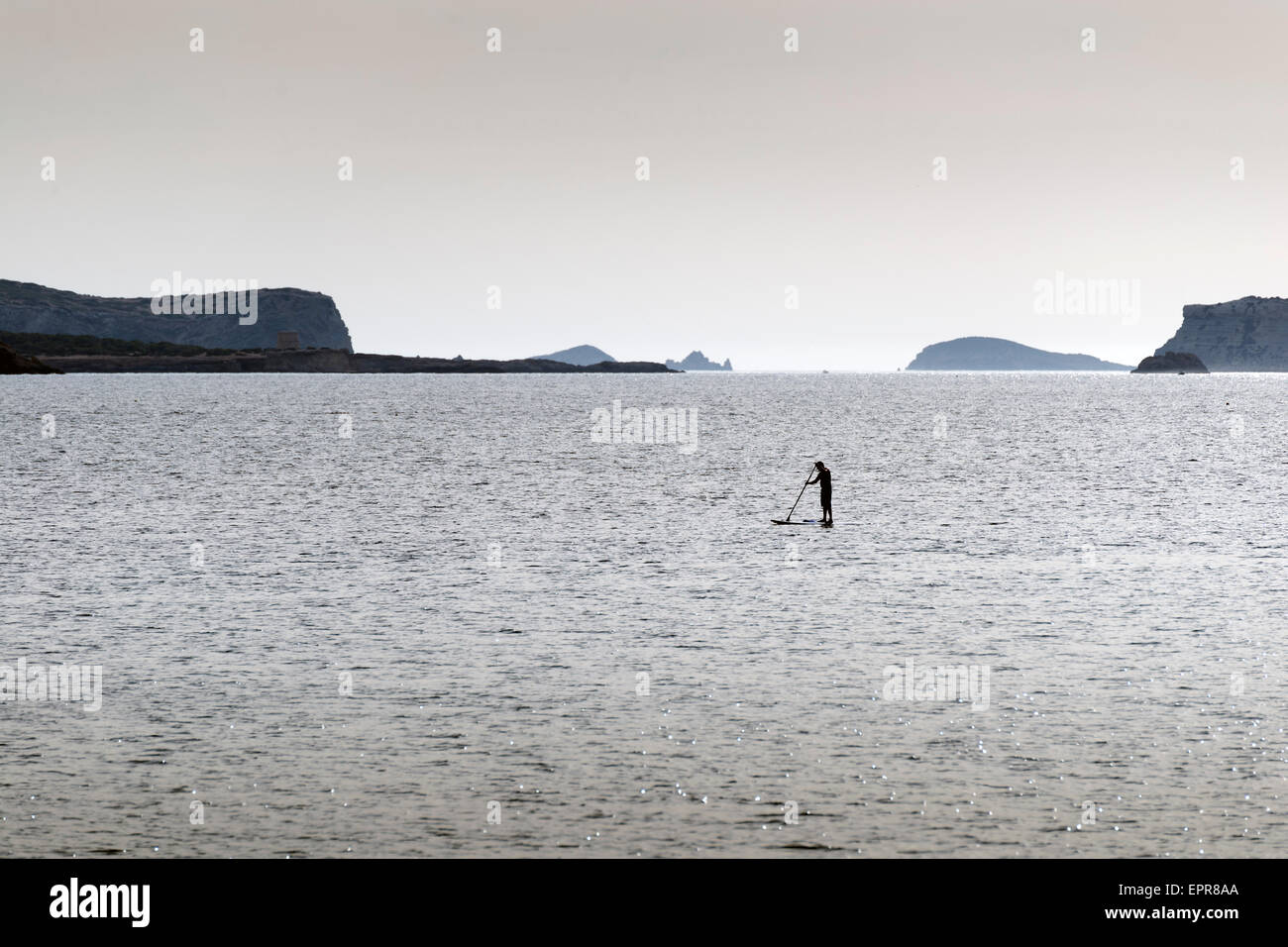 Silhouettes of Stand up paddle surfers (paddle boarders) at sunset. Ibiza coast Stock Photo