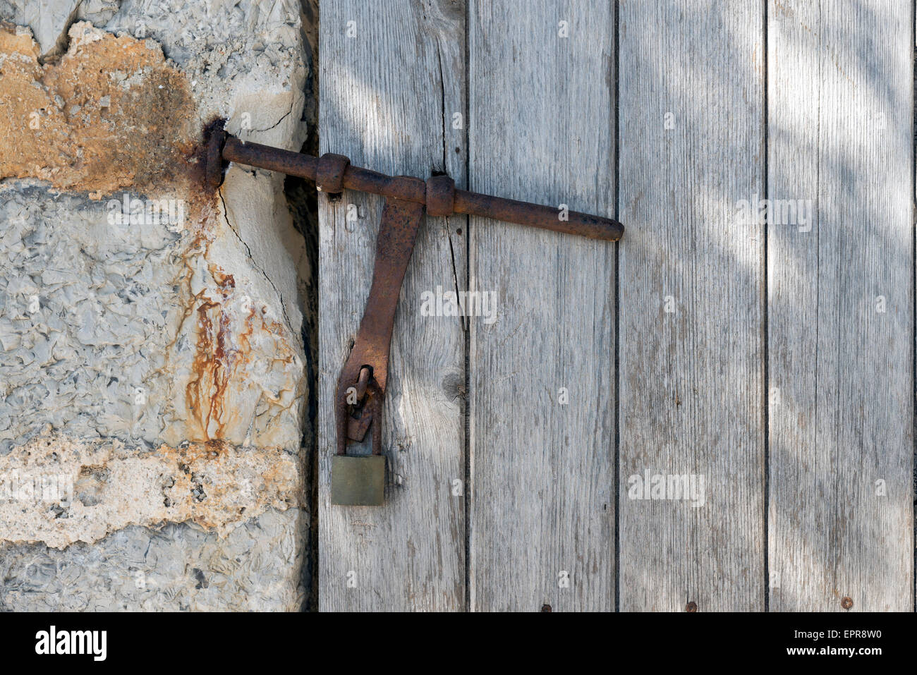 Metal grunge latch on the wood door. Stock Photo