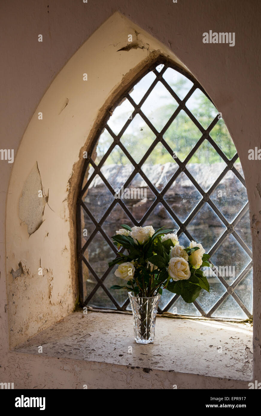 A floral display in the window of the entrance to St James Church, Buttermere, Lake District, Cumbria Stock Photo