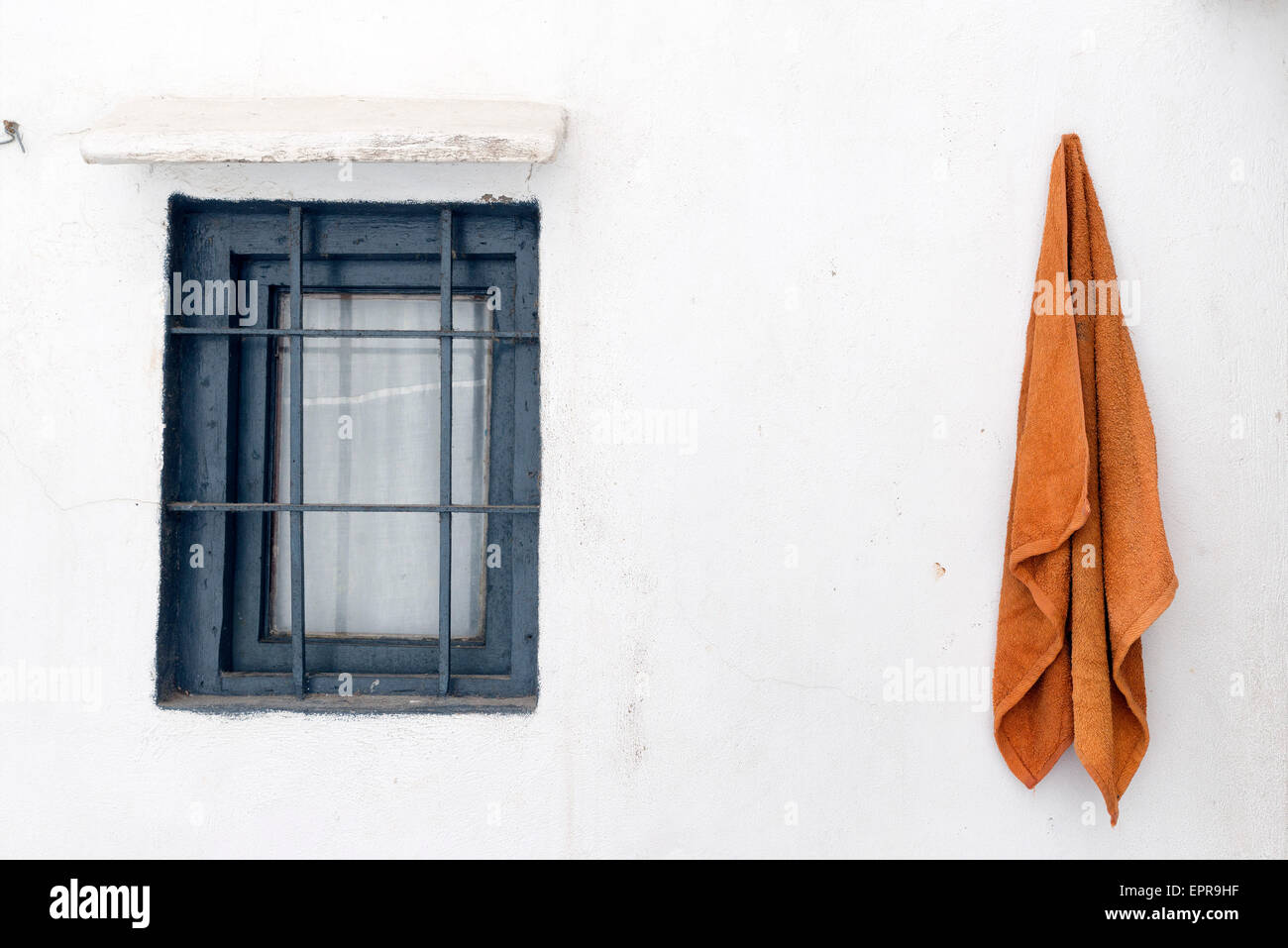 window and towel in a whitewashed wall in Ibiza Island Stock Photo
