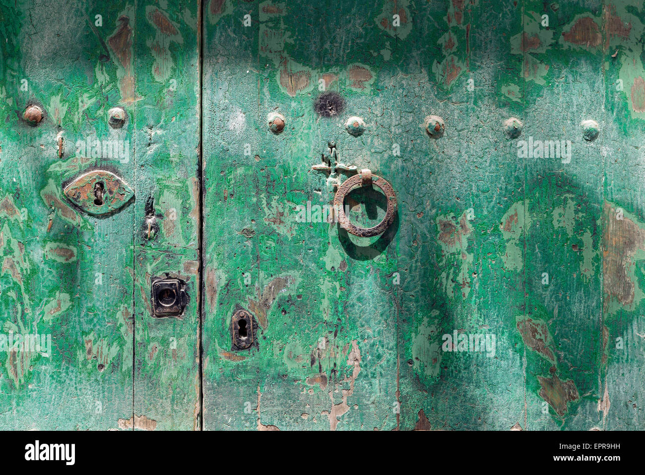 green painted door with lock and handle in round shape Stock Photo