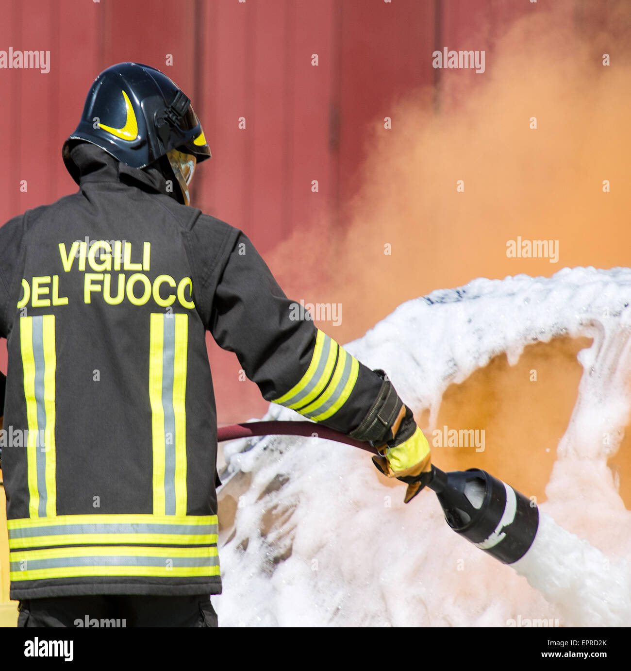 firefighters in action with foam to put out the fire of the car Stock Photo