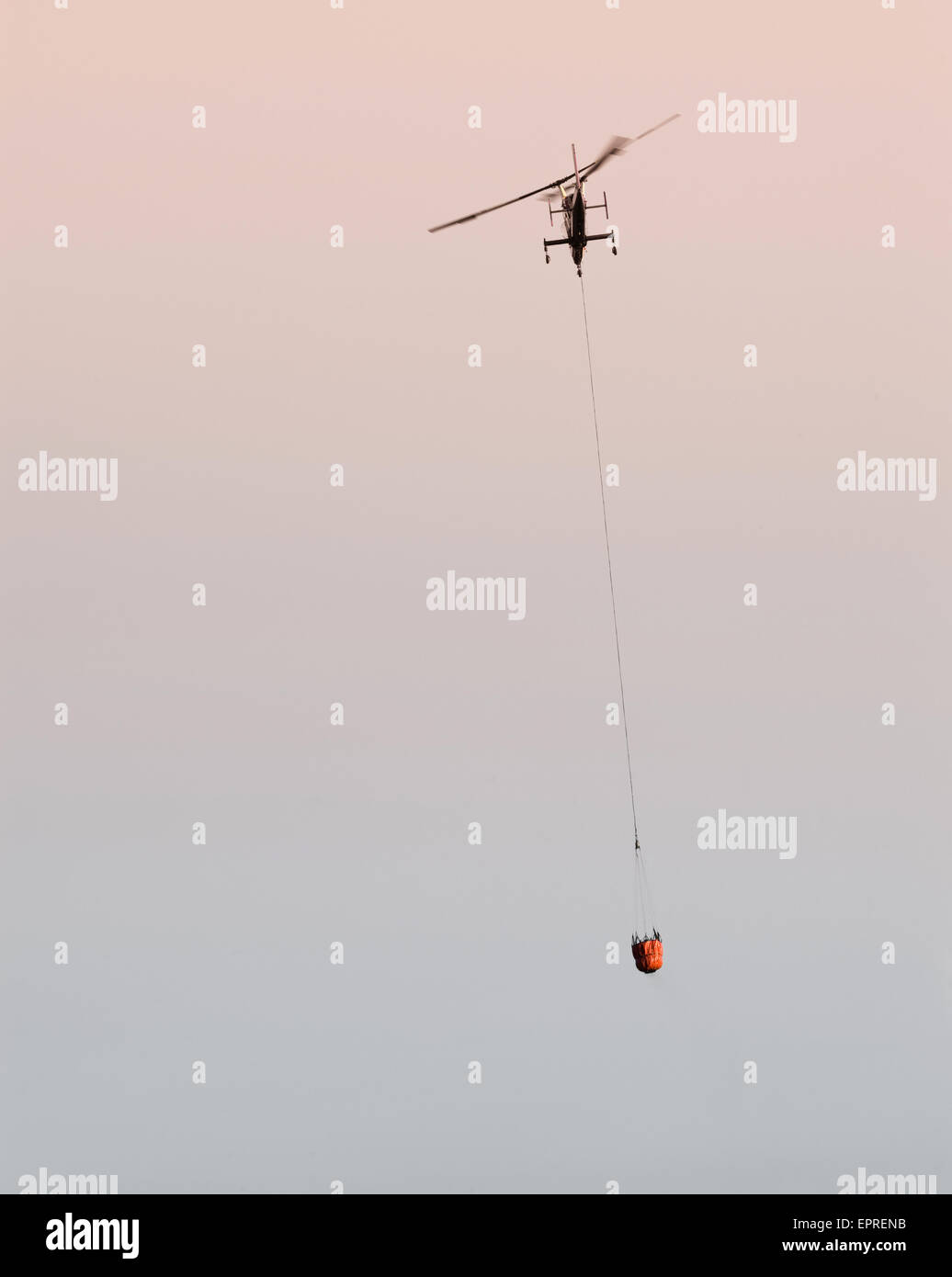 Helicopters pick up water from a reservoir while fighting wildfires in California Stock Photo