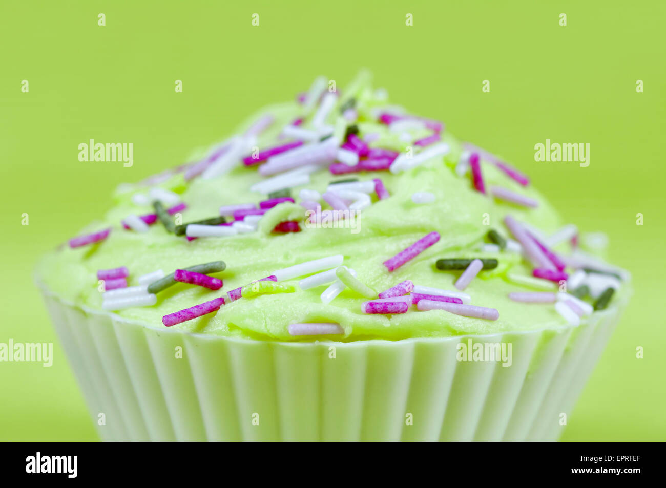 Pretty colourfully decorated cupcake or fairy cake with lime green