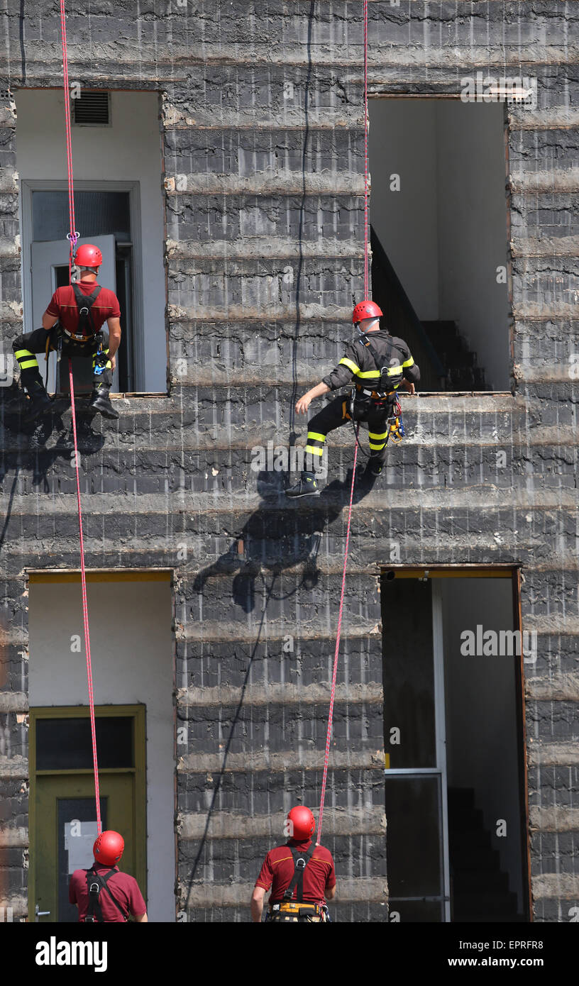 four firefighters during rescue drills in the Firehouse Stock Photo - Alamy