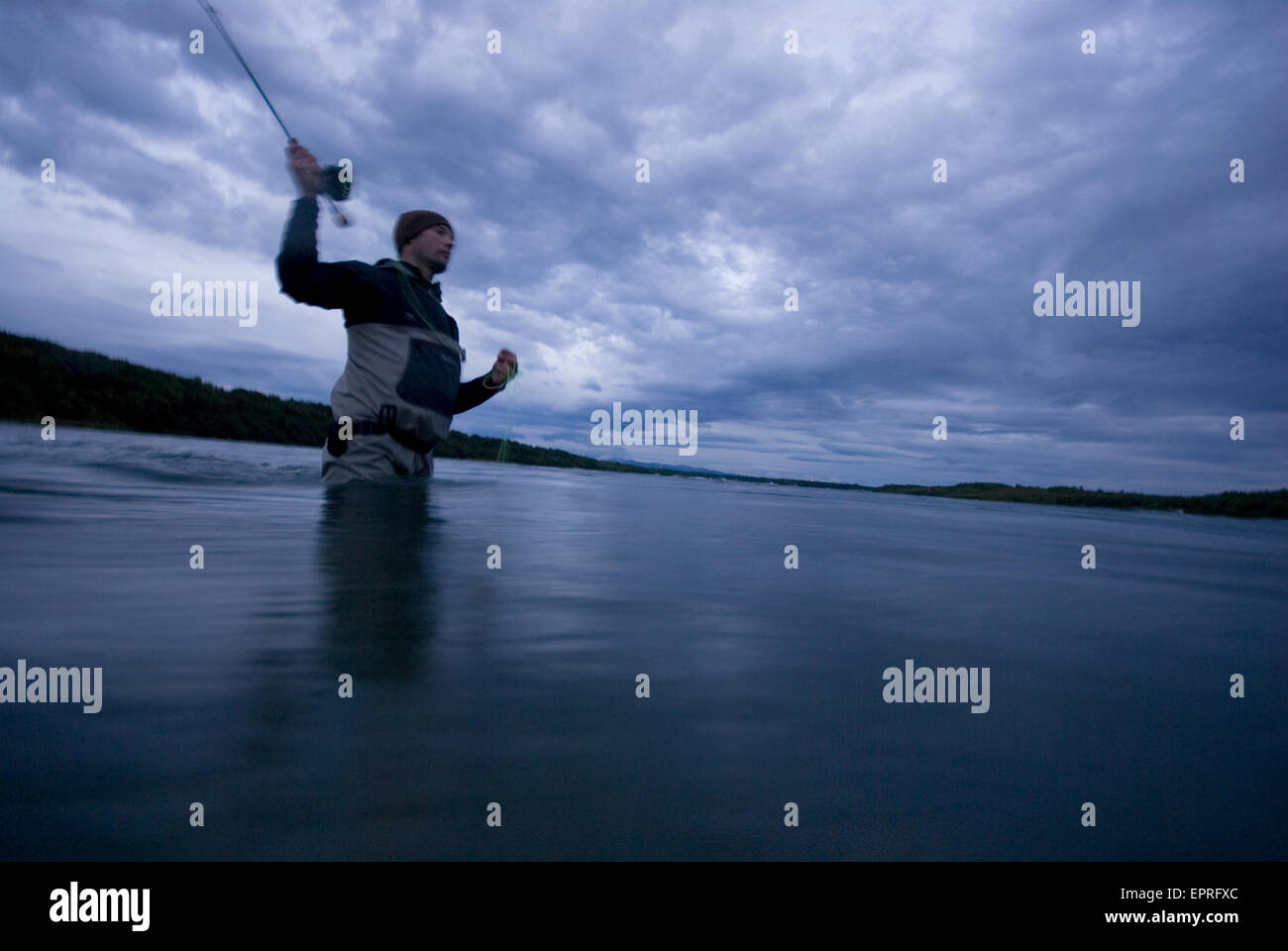 A fisherman casts his fly rod the on Lower Talarik River, AK. Stock Photo