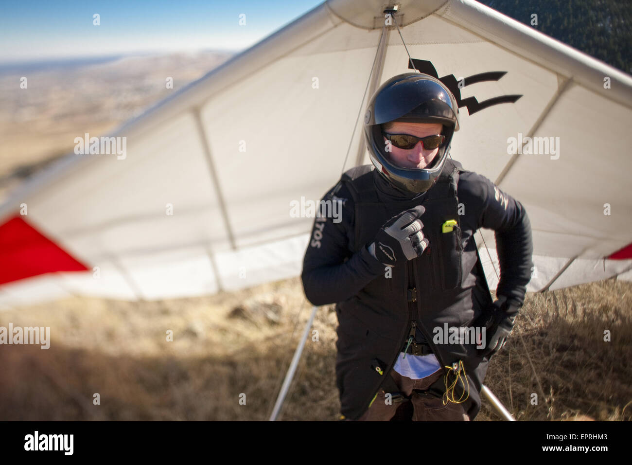 World record hang glider, BJ Herring checks his radio while on launch