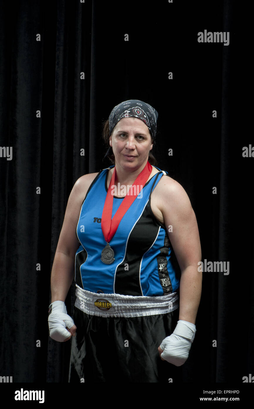 A forty three (43) year old boxer stands wearing her silver medal minutes after losing the Championship round at the Canadian Amatuer Boxing Championships in Saint-Hyacinthe, Quebec. Stock Photo