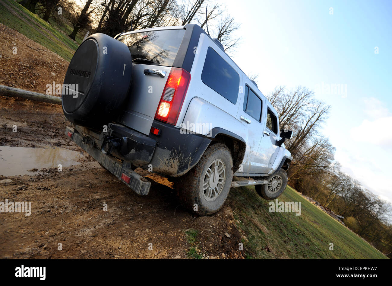 Hummer H3 driving off road and lifting a wheel Stock Photo