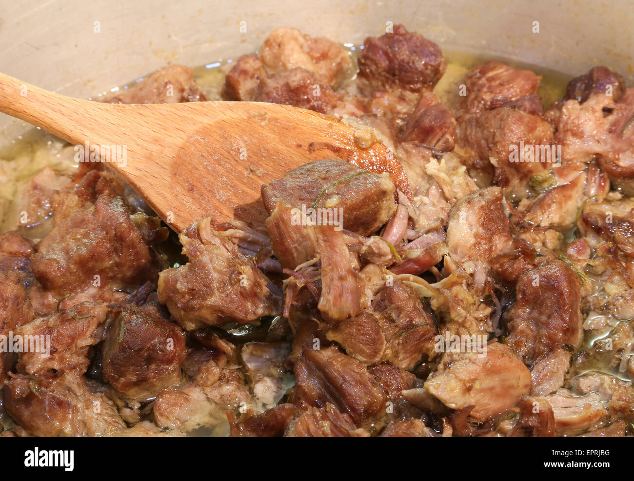 tasty meat stew in the pot of restaurant and a spoon Stock Photo
