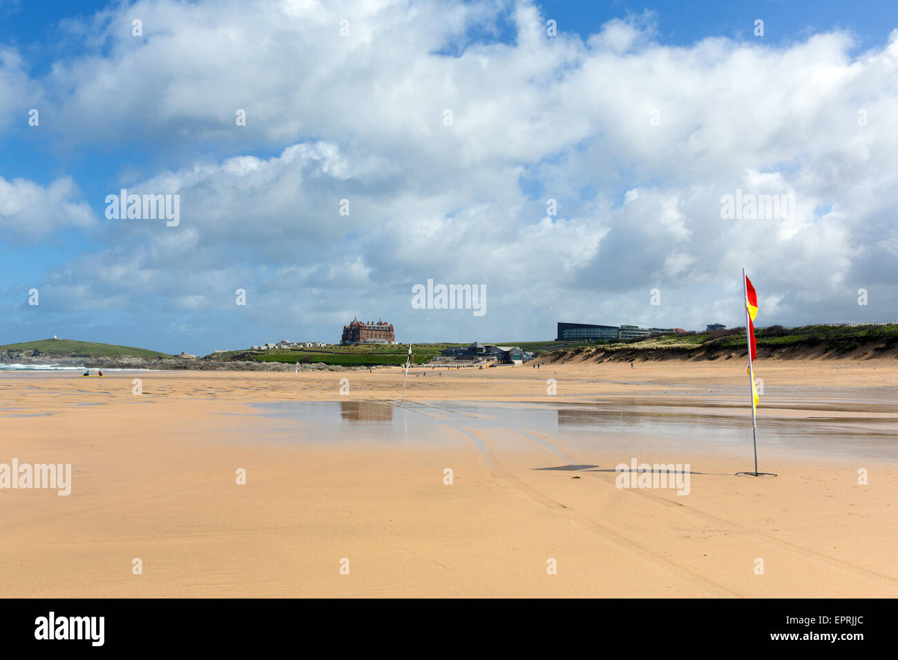 Fistral beach Newquay North Cornwall with red and yellow safety flag spring popular in the UK with blue sky in spring Stock Photo