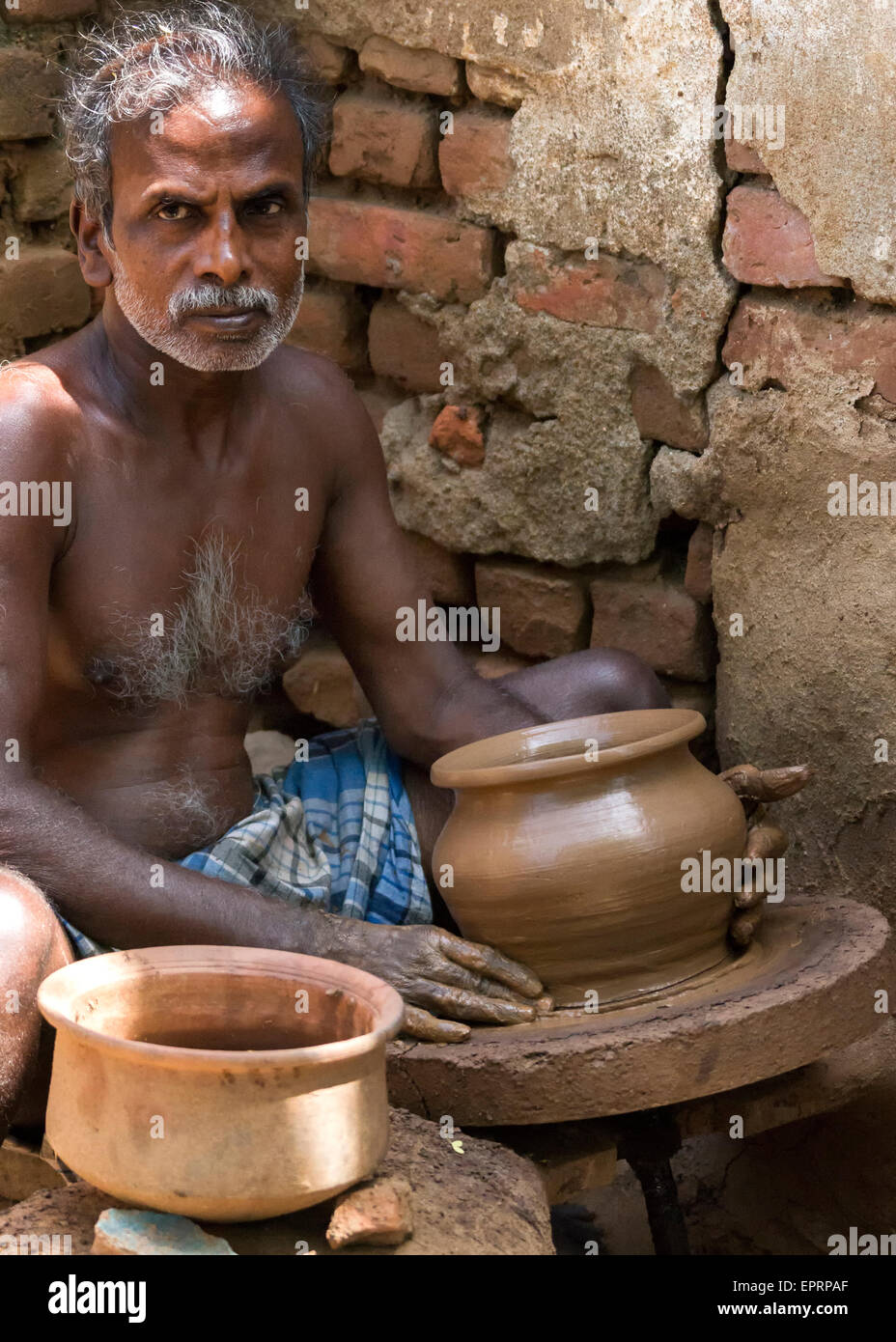 Pot maker at his turning table with finished product Stock Photo Alamy
