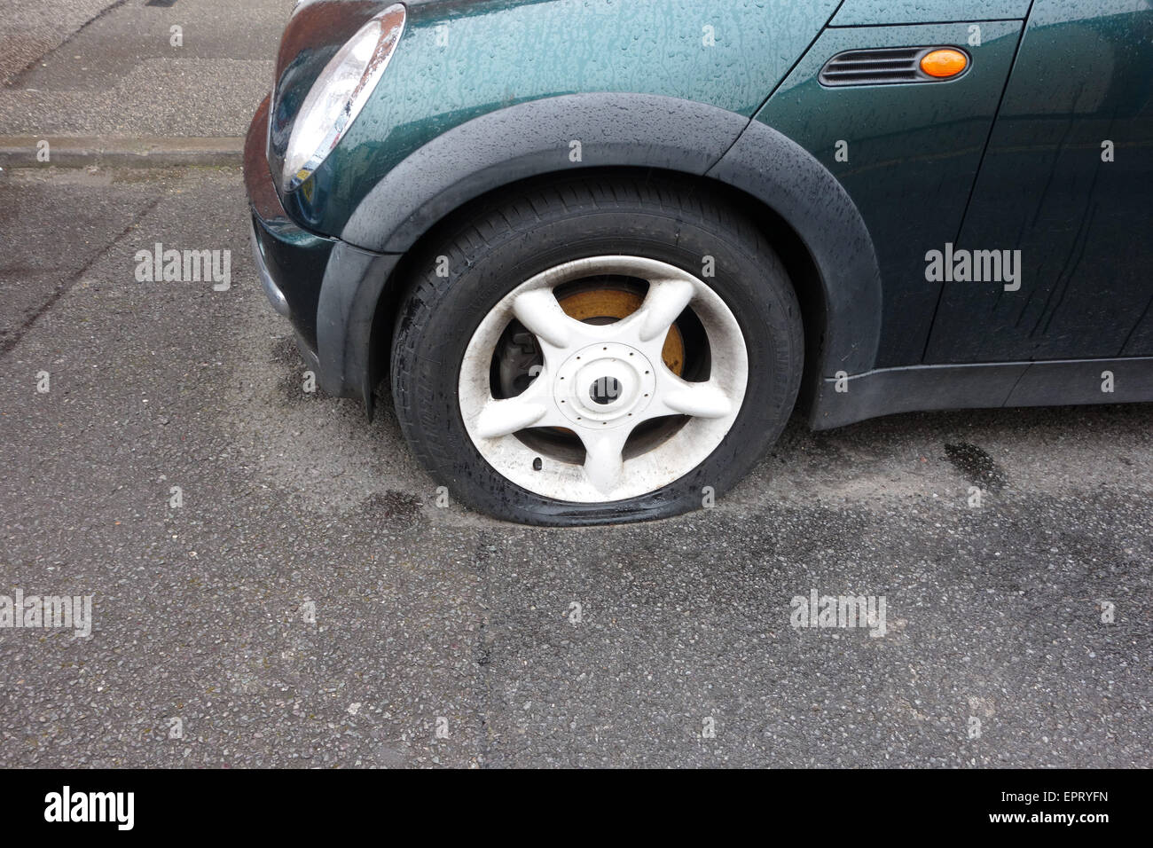 flat tire tyre on a rainy day Stock Photo