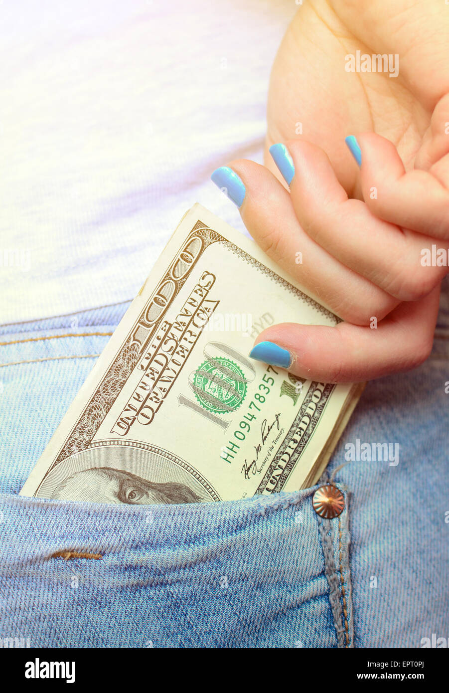 Woman hand taking money from jeans back pocket Stock Photo