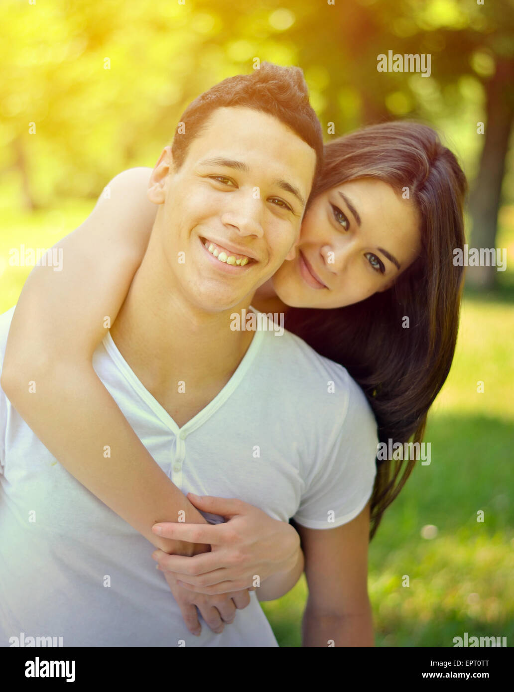 Couple hugging in a park Stock Photo - Alamy