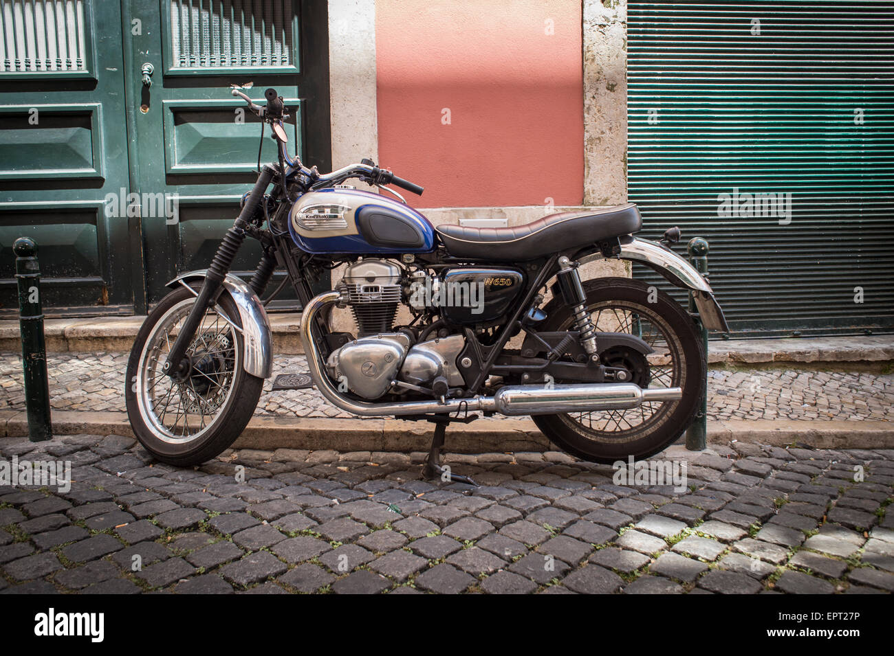 Kawasaki W650 motorbike parked on a cobbled street. Stock Photo